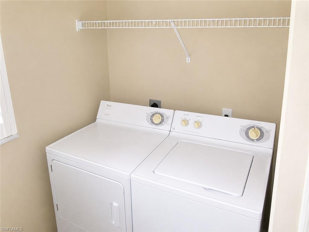 Dedicated laundry area featuring a white wire shelving unit and light beige wall paint
