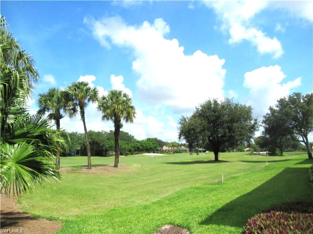 Expansive golf course frontage featuring manicured lawns and mature trees.