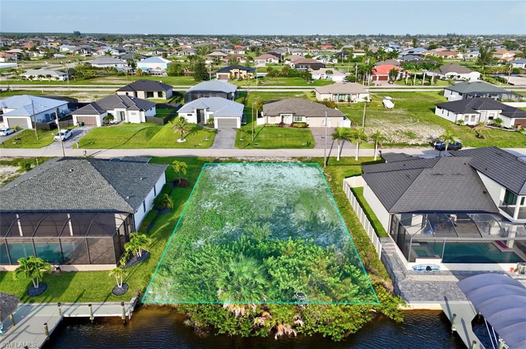 Waterfront lot featuring direct canal access and established neighborhood surroundings