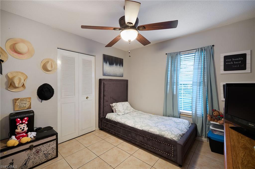 Room featuring tile flooring and a ceiling fan with integrated lighting