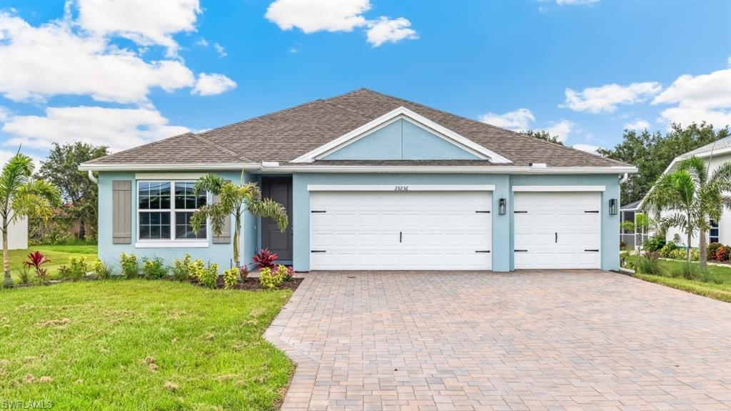 Model home. Single story home with a front lawn, a garage, stucco siding, and decorative driveway