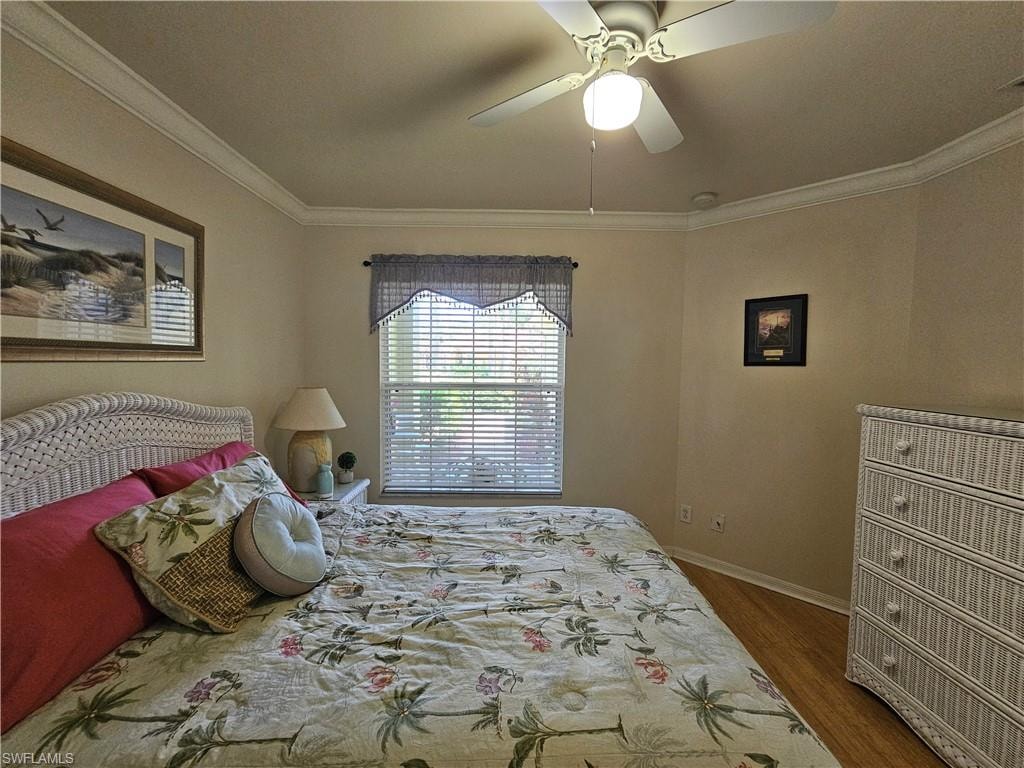 Recessed window with blinds, crown molding, and a ceiling fan with integrated lighting