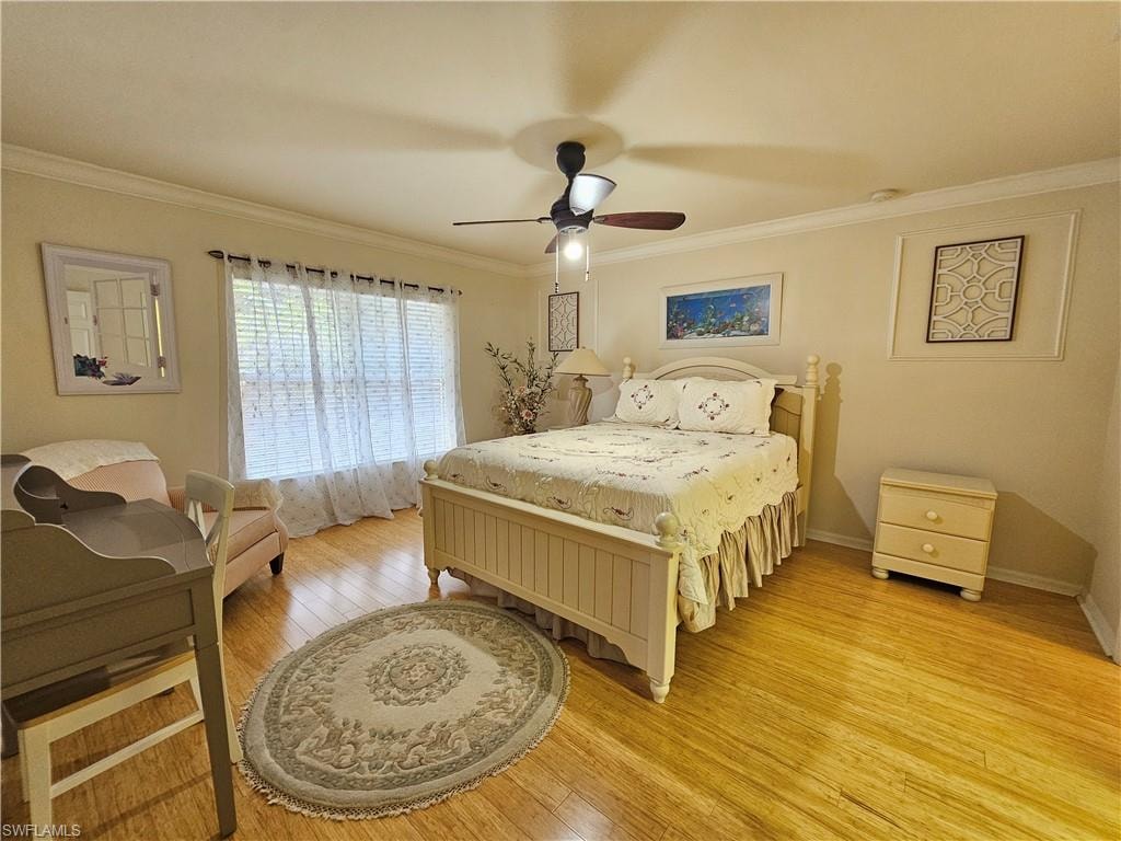 Bright room featuring wood-finish flooring and crown molding