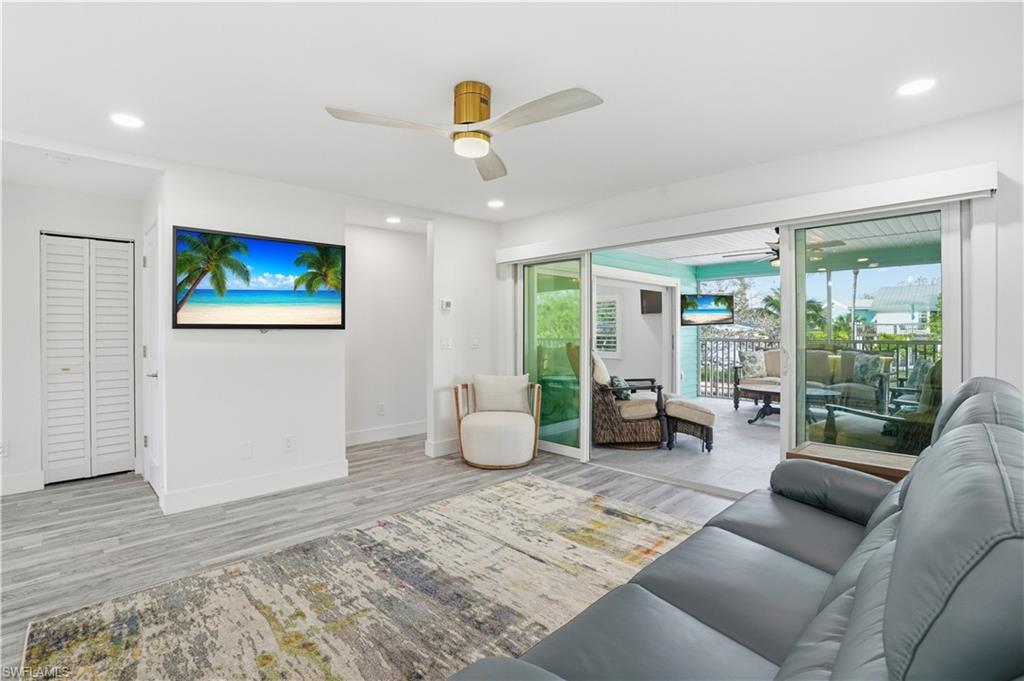 Living room with ceiling fan, wood finished floors, and recessed lighting - Virtually Edited Image