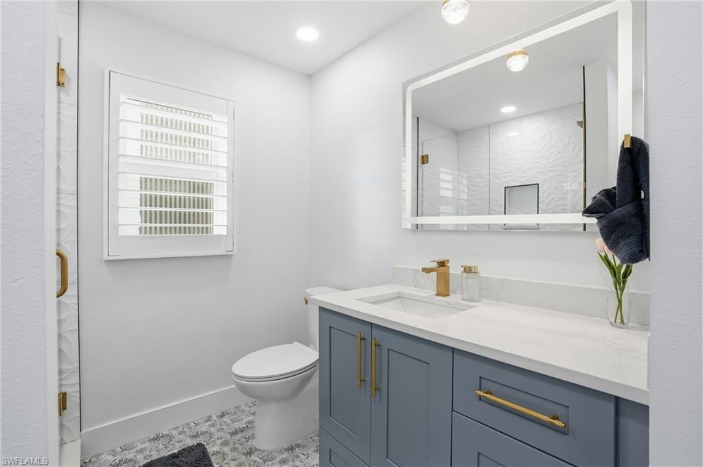 Bathroom featuring vanity, a shower stall, and recessed lighting - Virtually Edited Image