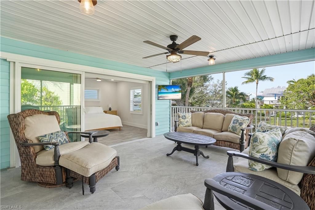 Sunroom / solarium with an outdoor living space and a ceiling fan - Virtually Edited Image