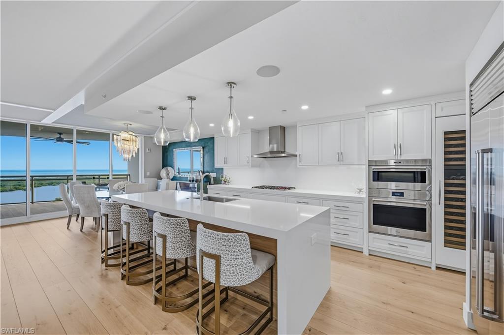 Large Quartz Island in Open Floor Plan Kitchen Dining