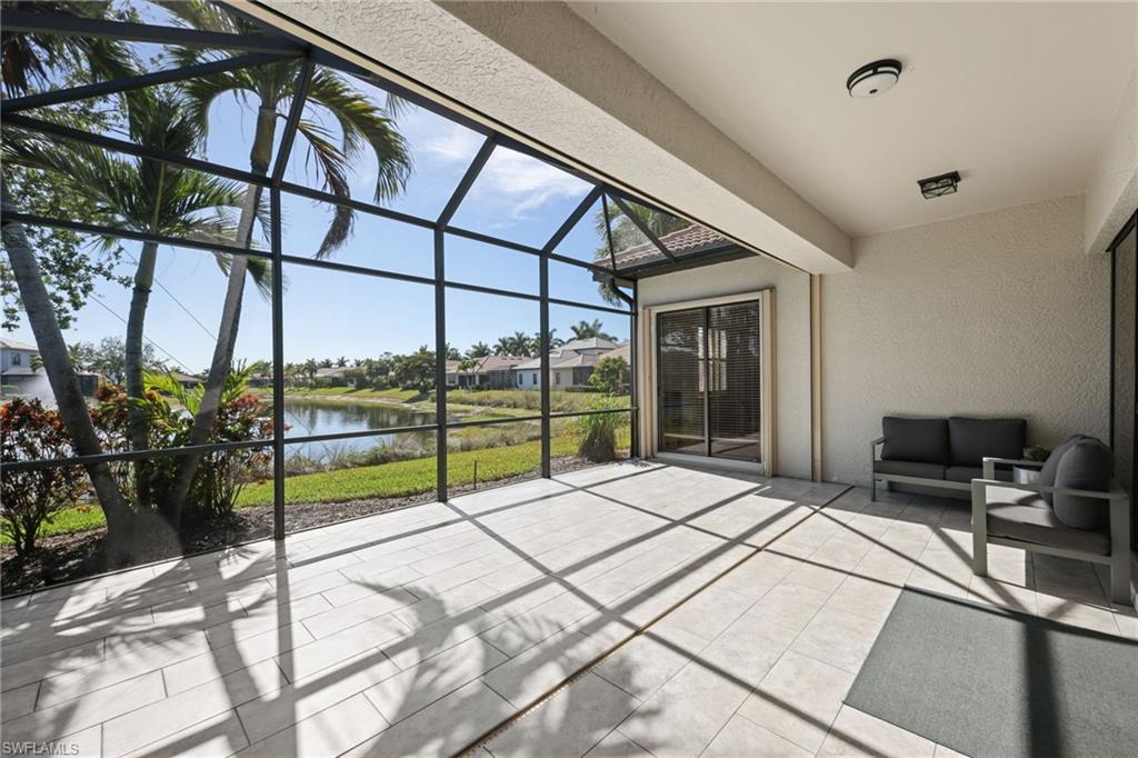 Screened lanai featuring large format tile flooring and a textured ceiling
