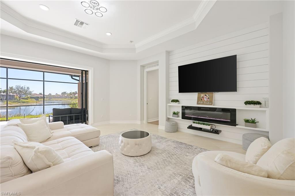 Living area featuring large sliding glass doors opening to a screened outdoor space