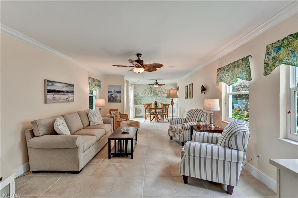Spacious living area with tile floors and lots of windows