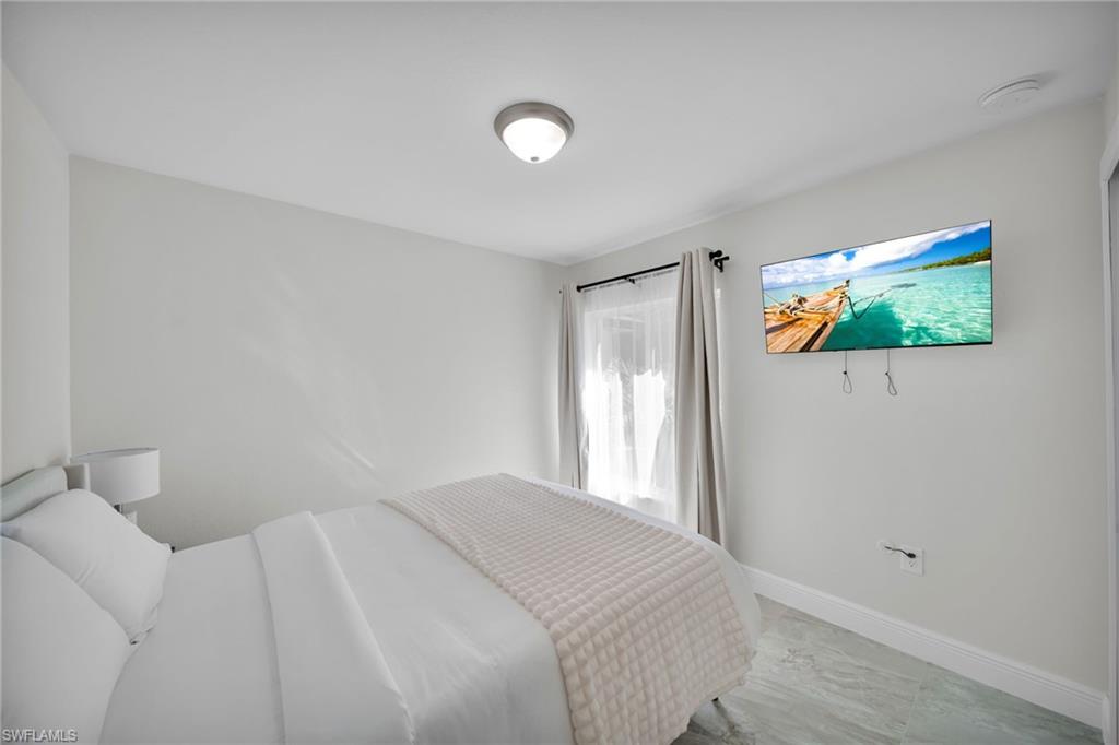 Light-toned walls complement the gray-toned tile flooring and white baseboards
