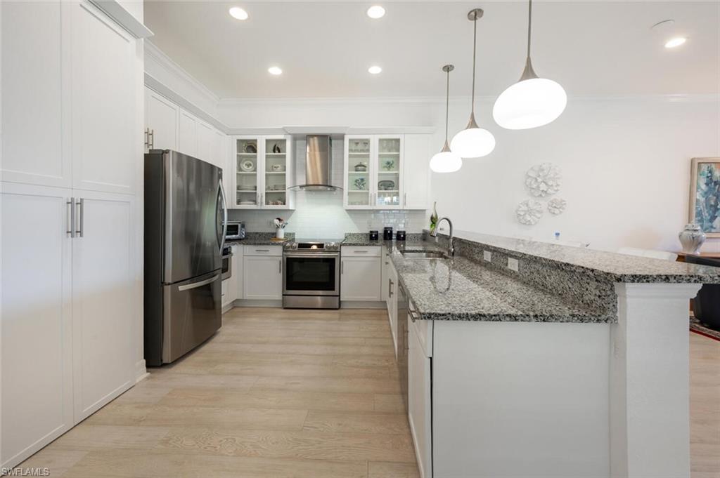 Hood Vent over the stove, built in microwave drawer and glass cabinets for an upgraded modern feel