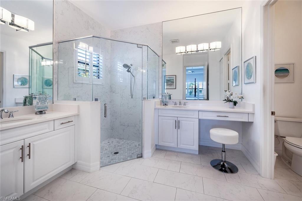 Separate vanity/sink areas with large walk in shower and separate water closet