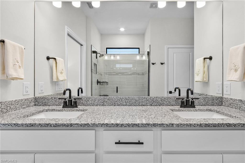 Dual vanity with gray speckled countertop and undermount sinks
