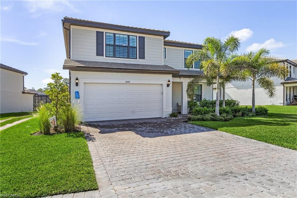 Contemporary two-story residence with a paved driveway and an attached two-car garage