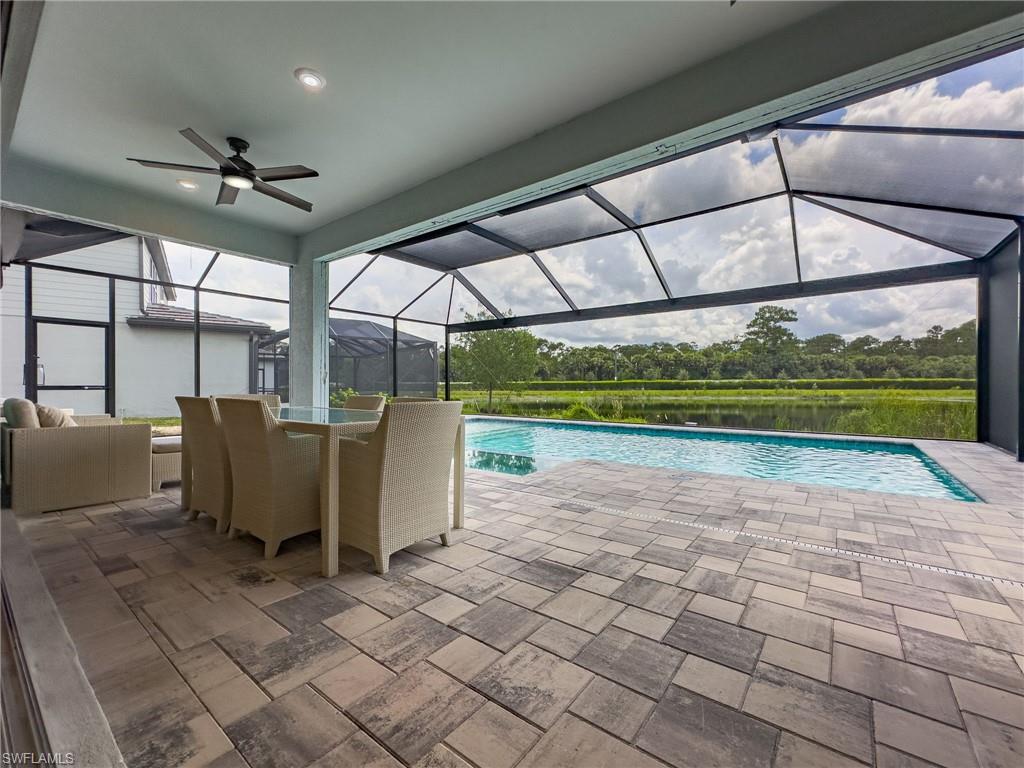 Screened lanai featuring a swimming pool and expansive paver patio