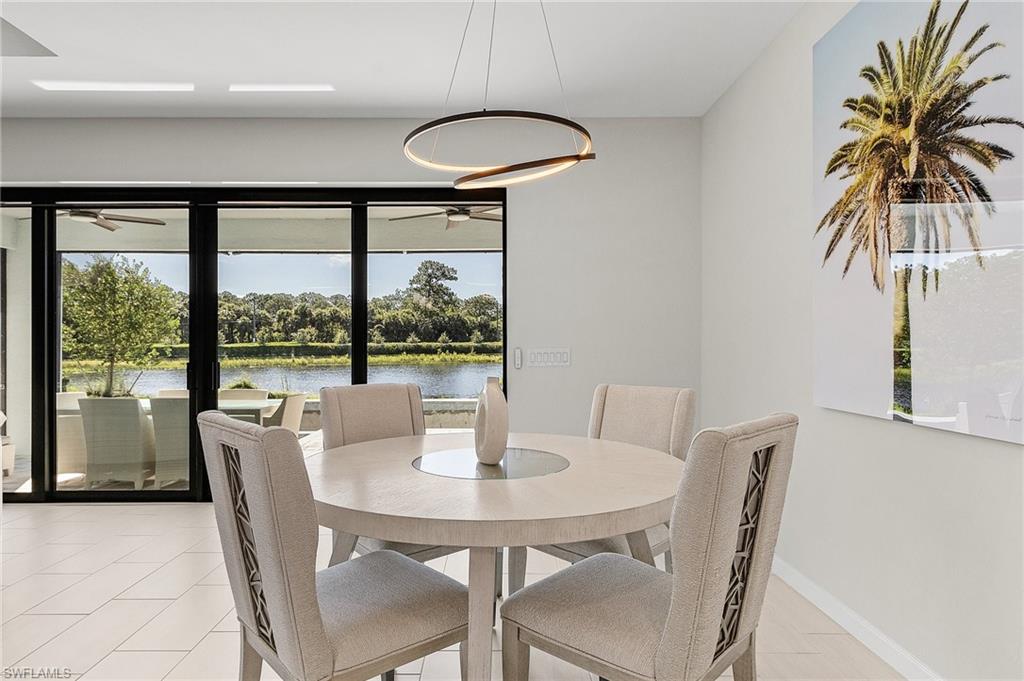 Dining area featuring expansive glass sliding doors opening to an outdoor patio