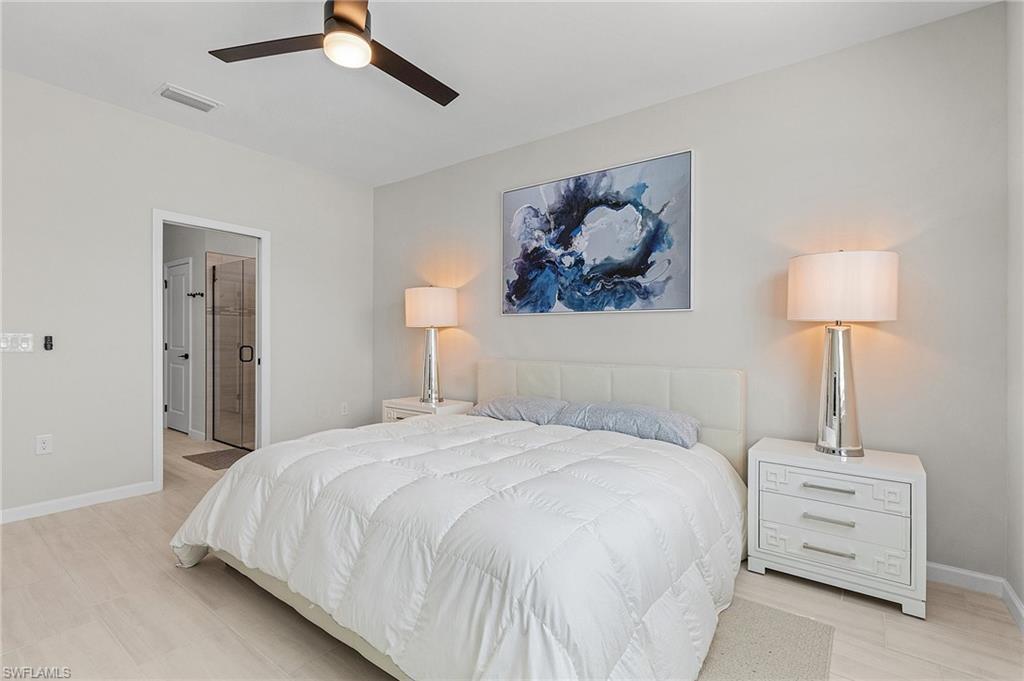 Light-toned wood-finish flooring complements the neutral wall color