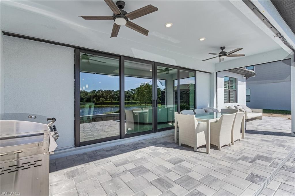Covered patio featuring paver flooring, recessed lighting, and two ceiling fans