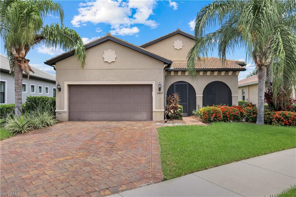Screened-in Patio at the front door, a tile roof, featuring an arched entryway.