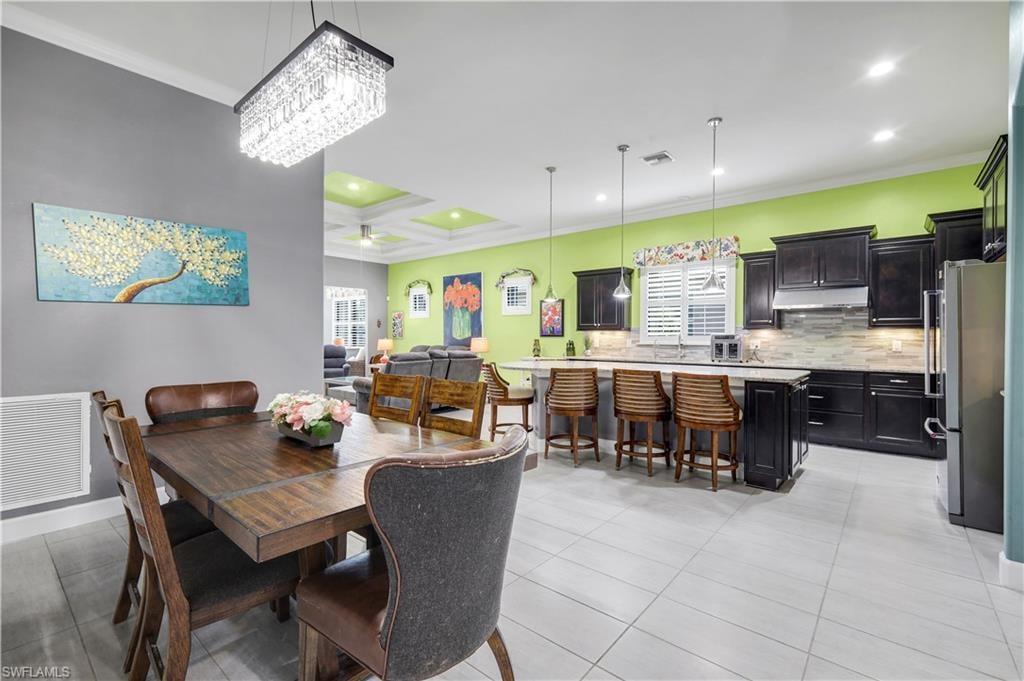Open-concept kitchen and dining area featuring a crystal chandelier