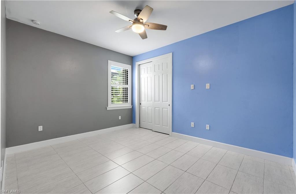 Additional Bedroom with tile-plank flooring and plantation shutters