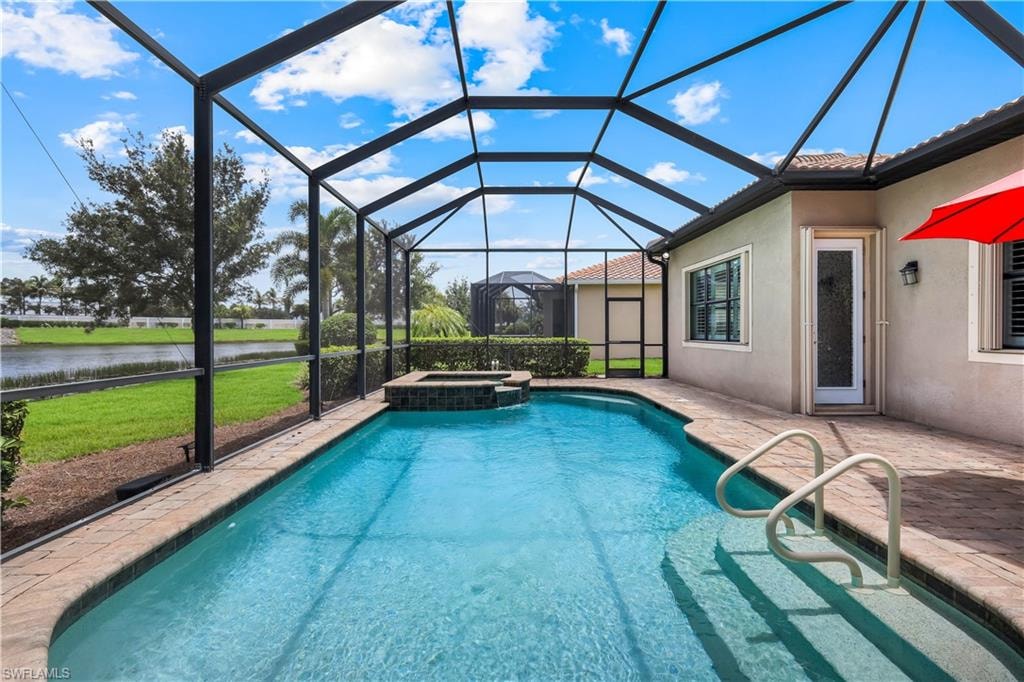 Screened outdoor living area featuring a pool with an integrated spa, brick paver decking.