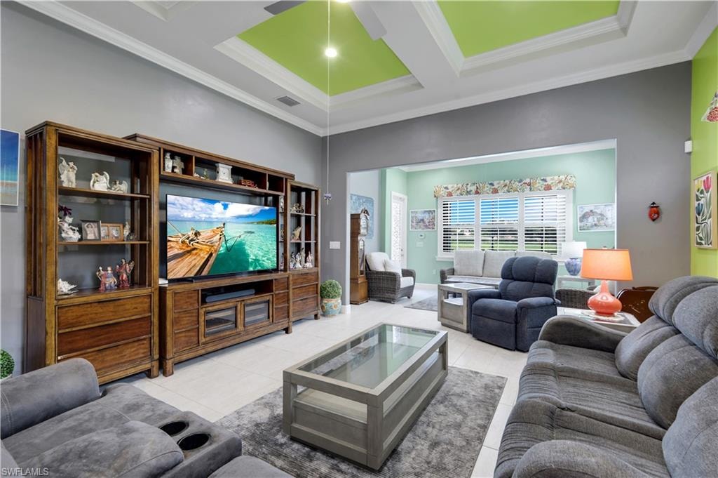 Expansive living area featuring a tray ceiling with accent lighting, tile flooring, and a Sunroom.