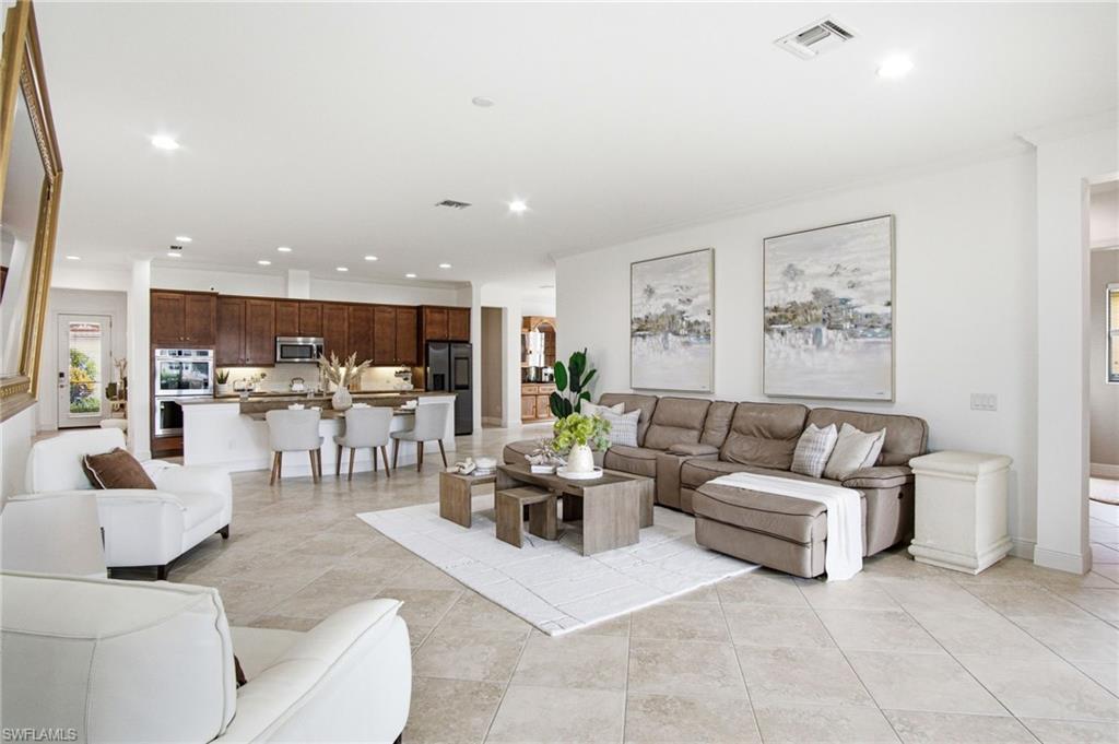 The OPEN great room is expensive, bright and filled with natural light with a triple plant panel full glass Slider that Roets to just one panel when fully opened in the cooler months to enjoy all that Florida has to offer.