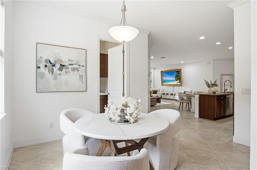 The eat in dining area is spacious and bright with a beautiful exposure natural light streaming through the window wall