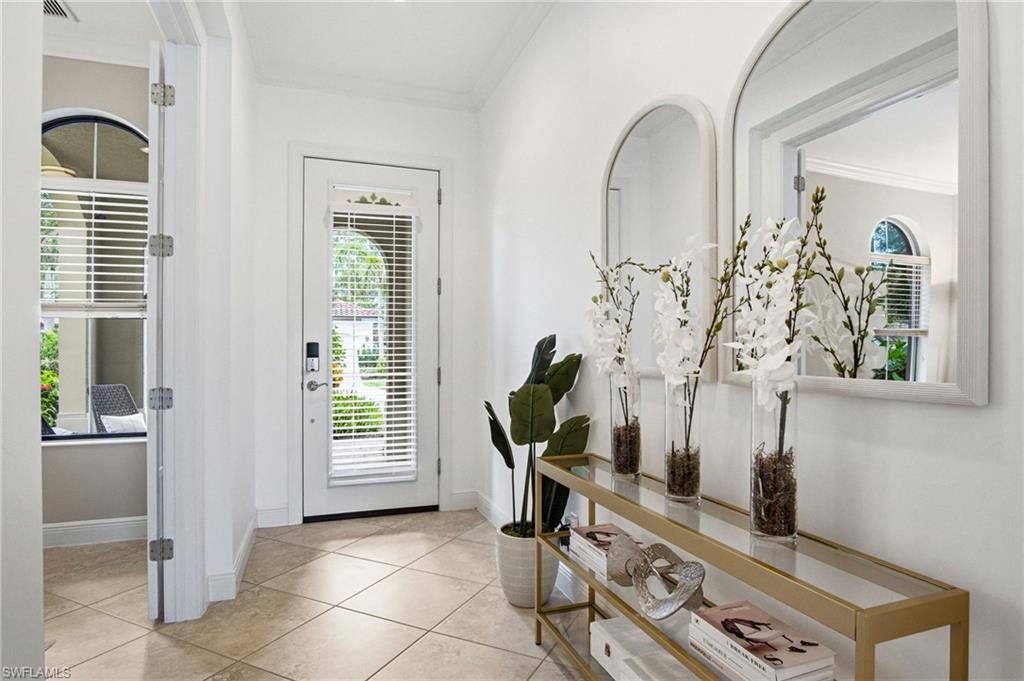Spacious and bright entry foyer create a modern wow factor for guests with oversized openings, doors, and ceiling height throughout.