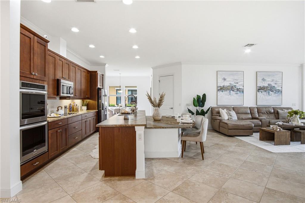 The OPEN kitchen floor plan feels modern yet delivers functionality for a chef and larger entertaining. Custom leathered, exotic countertops are a showstopper!