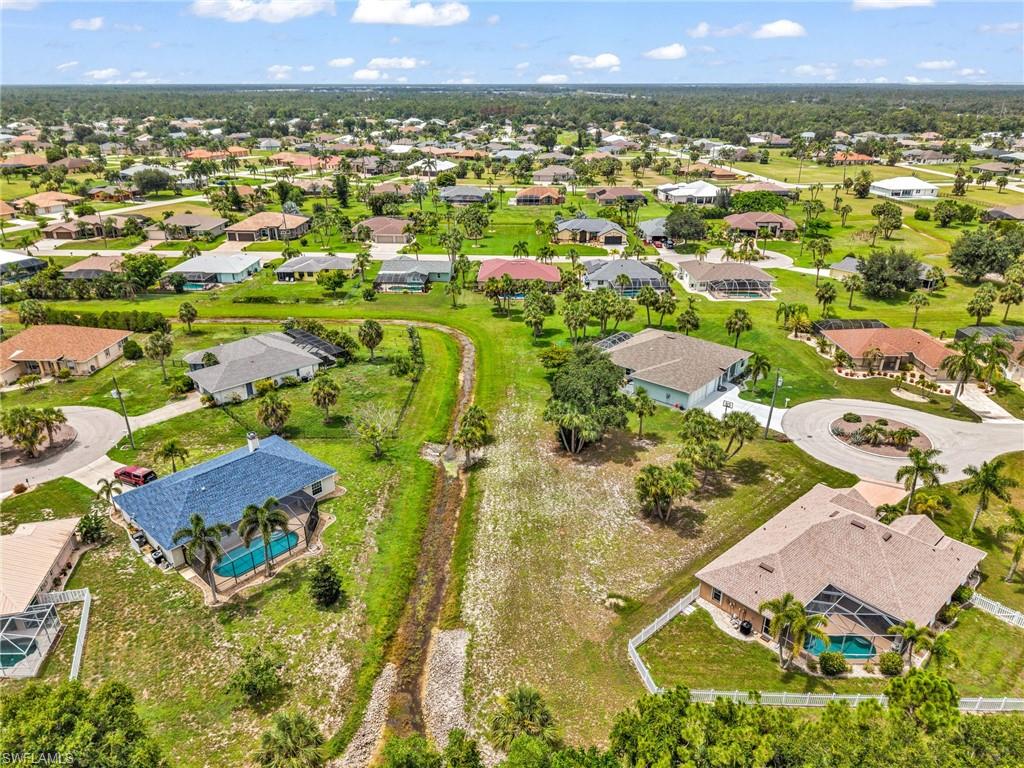 Expansive residential neighborhood featuring single-story homes, mature landscaping, and private swimming pools with screened enclosures