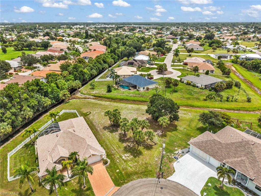Aerial perspective showcasing multiple properties and expansive green spaces