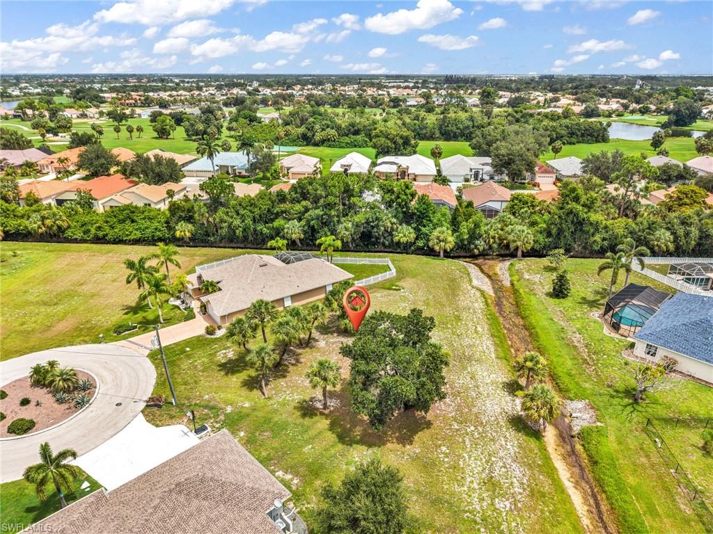 Aerial perspective showcasing a single-story residence with a beige tiled roof