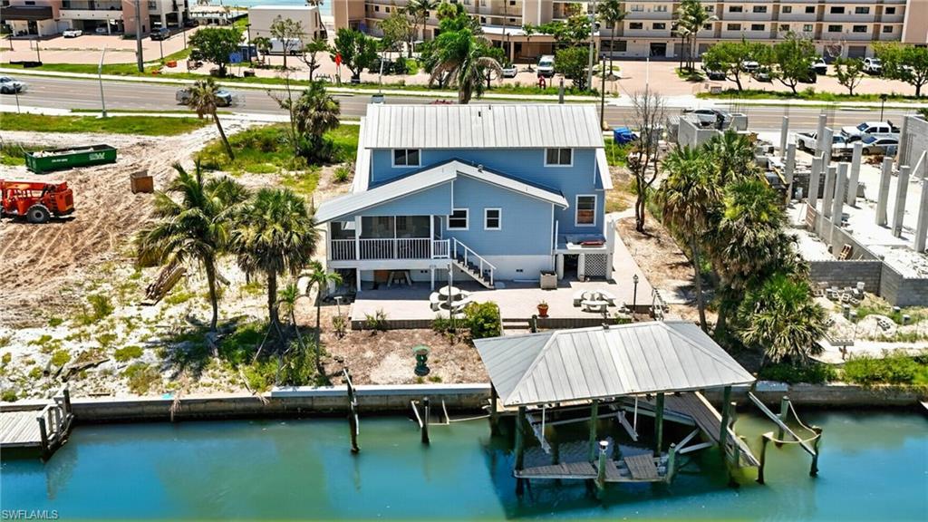 Aerial view of property and surrounding area featuring a large body of water - Virtually Edited Image