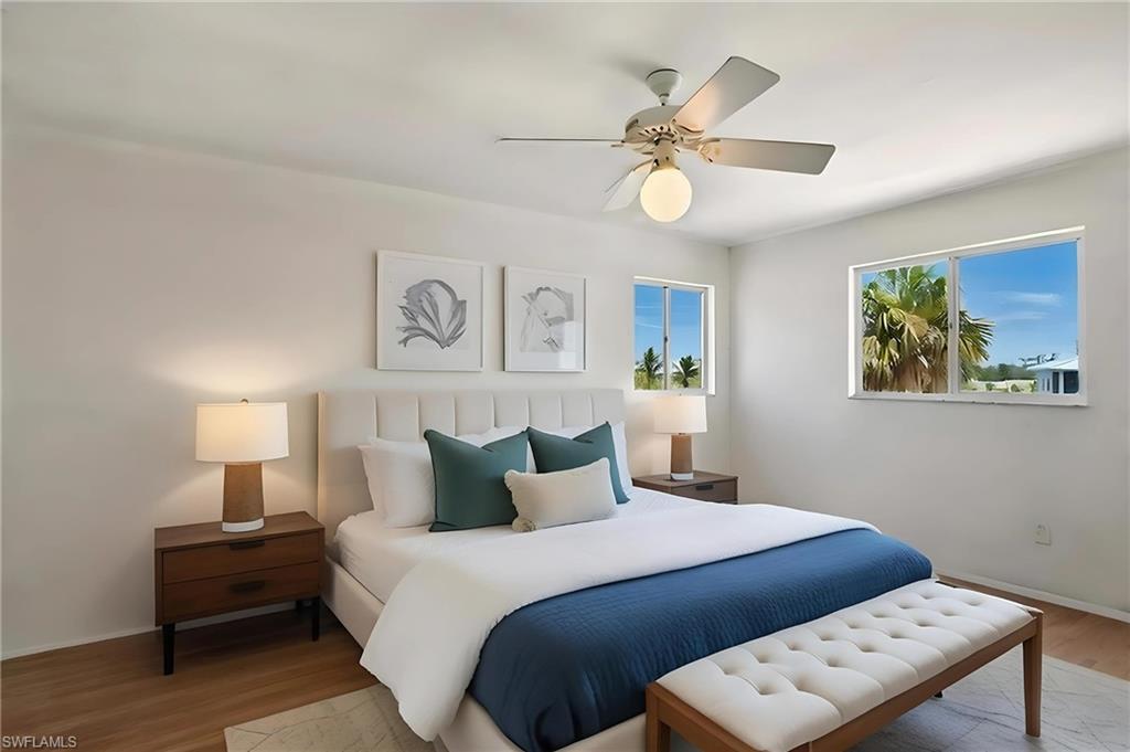Bedroom 2 with wood finished floors and a ceiling fan - Virtually Staged and Edited Image 2nd floor