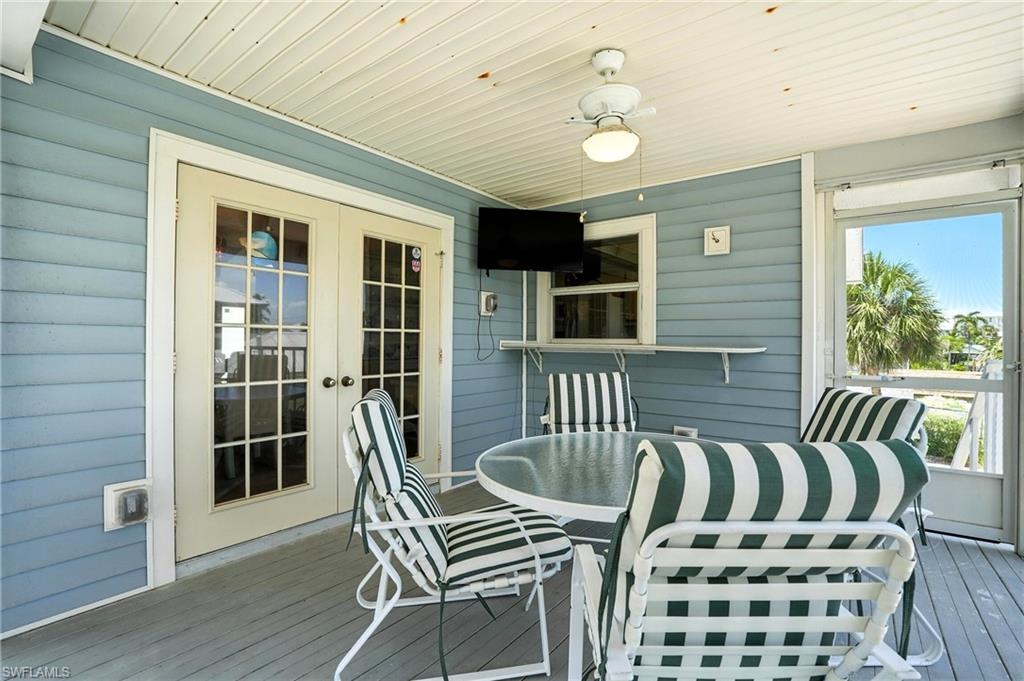 Wooden terrace with french doors and outdoor dining space - Virtually Edited Image