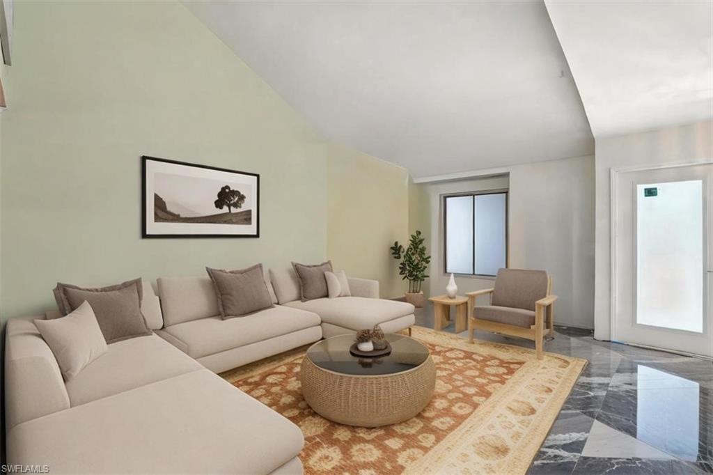 Living area featuring vaulted ceiling and marble finish floors - Virtually Staged and Edited Image
