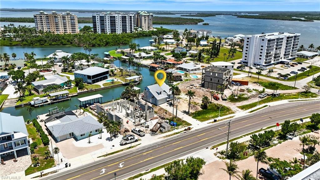 Drone / aerial view of apartment complex and a nearby body of water - Virtually Edited Image