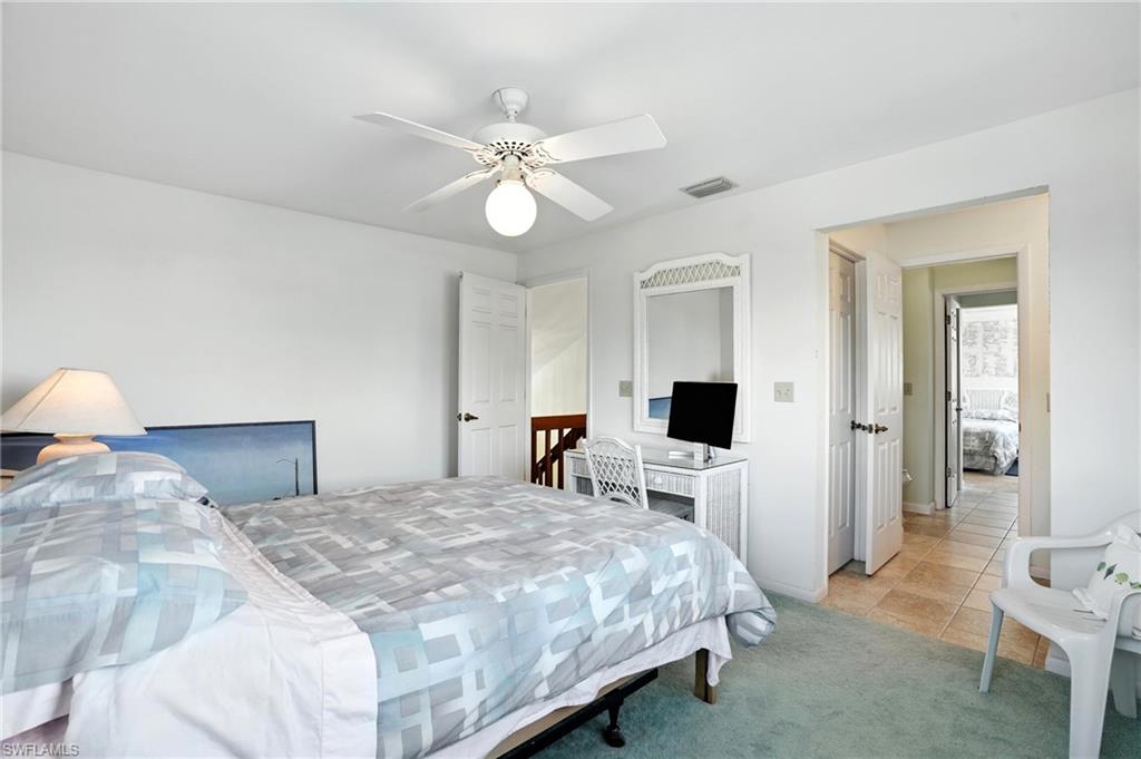 Bedroom 3 featuring light colored carpet, light tile patterned flooring, and a ceiling fan - Virtually Edited Image. 2nd floor