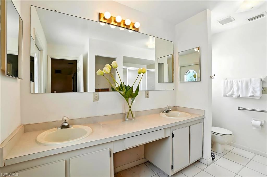 Bathroom with double vanity and tile patterned floors - Virtually Edited Image