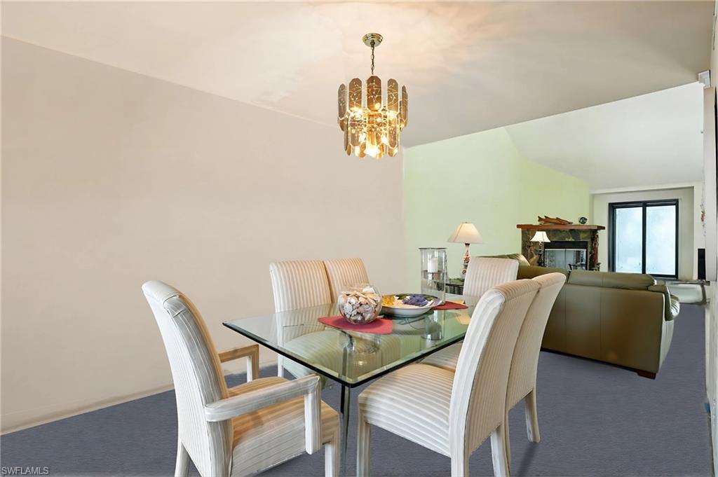 Dining space with carpet flooring and a chandelier - Virtually Edited Image