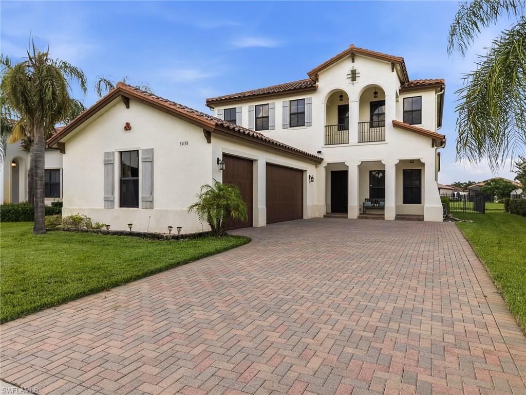 Stucco exterior with a tile roof and decorative shutters