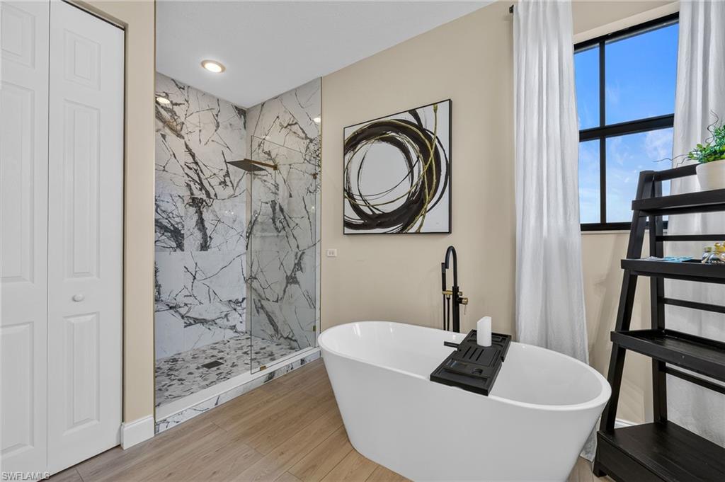 Freestanding soaking tub and walk in shower with upgraded tile