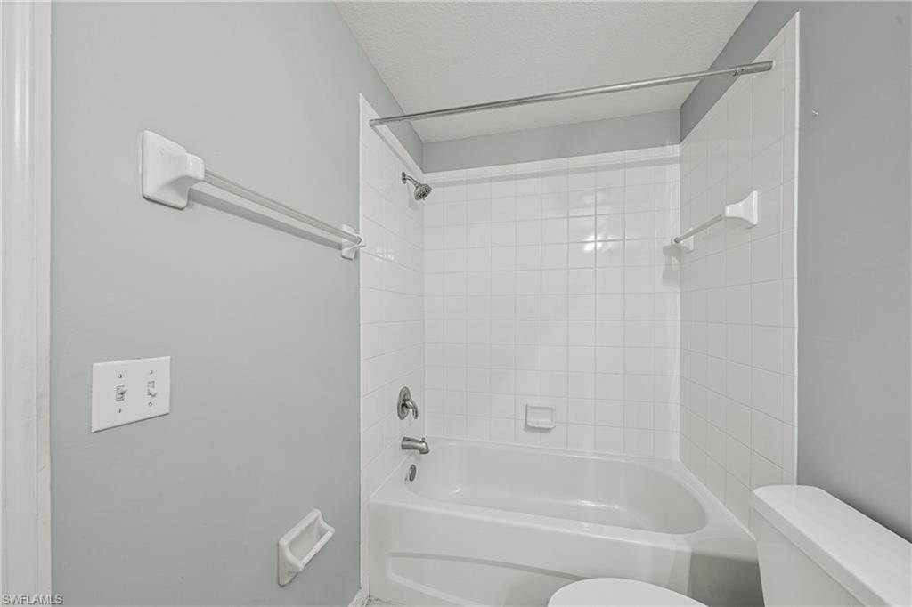 Bathtub and shower combination featuring white subway tile surround