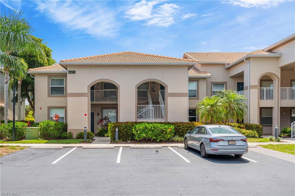 Multi-story building featuring a neutral stucco exterior with contrasting trim