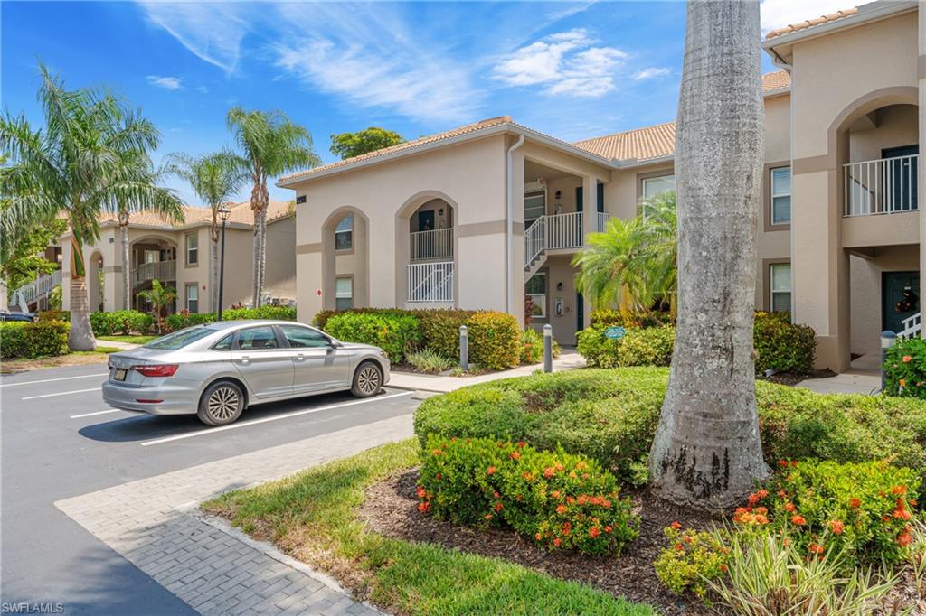 Multi-story residential buildings featuring arched entryway details and stucco exteriors