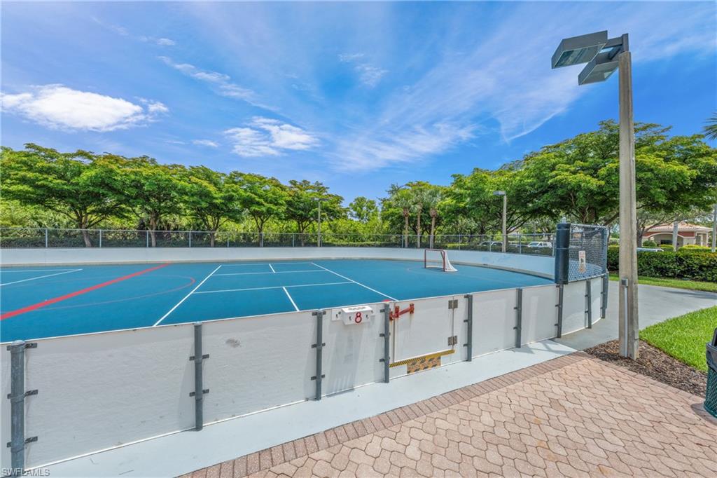 Outdoor multi-sport court featuring blue surfacing with white and red court lines