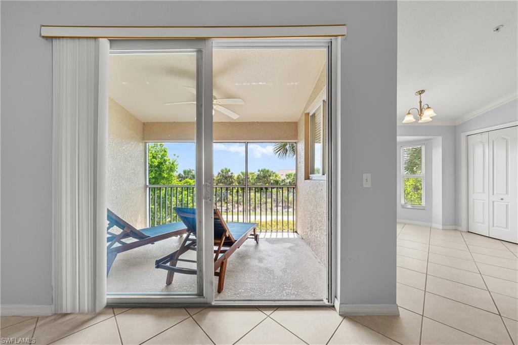 Screened balcony with a ceiling fan, offering outdoor living space